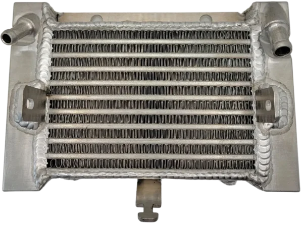 A radiator with many pipes and wires on it