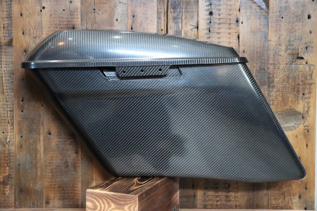 A black motorcycle side case on the wall