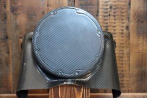 A black round shaped object sitting on top of a wooden table.