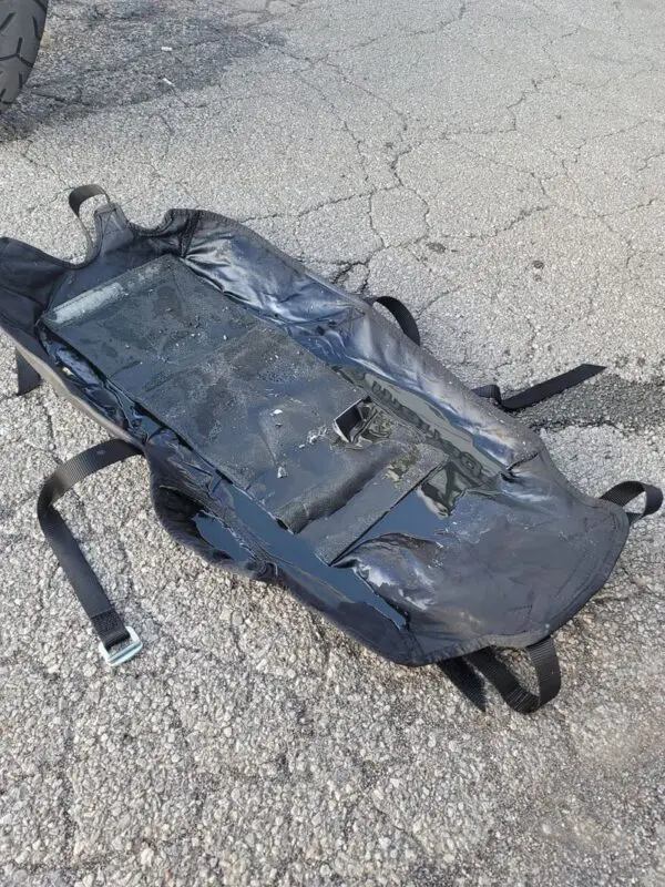 A backpack that is laying on the ground.
