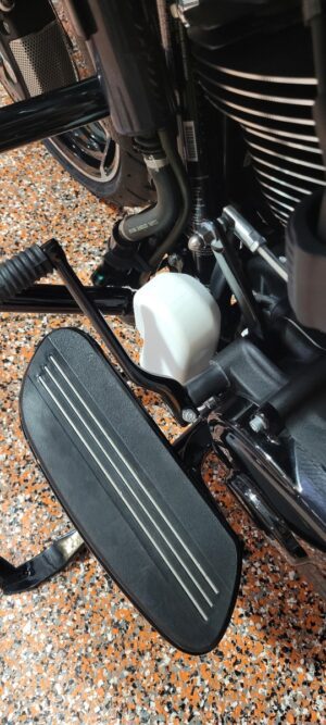 Close-up of a motorcycle's footpeg.